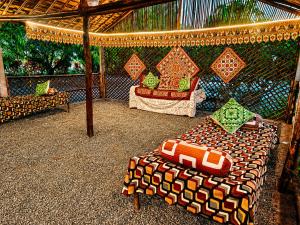 a room with a bed and a couch and a table at Vanveli The Forest Resort in Sasan Gir