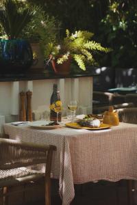 a table with a plate of food and glasses of wine at LE CLOS DES ARÔMES in Cassis
