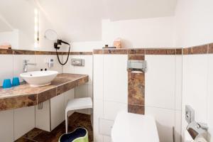 a bathroom with a sink and a mirror at Scheelehof - Ein Lieblingsplatz Hotel in Stralsund +63 photos