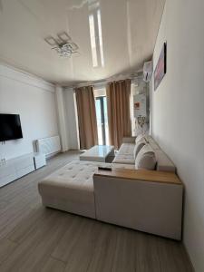 a large room with two beds and a tv at Happy Apartments Mamaia Nord 2 Camere in Mamaia Sat/Năvodari