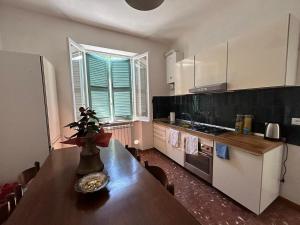 a kitchen with a wooden table with a vase on it at laperladelfarfa in Castelnuovo di Farfa