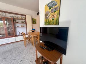 a living room with a television and a table at Ulivo Liguria With pool in Gazzelli