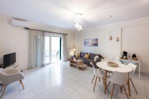 a living room with a table and a couch at Makis Apartments in Tsoukalades
