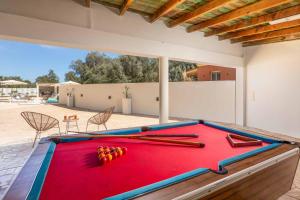 a pool table with balls on top of it at Villa Elegio in Kavos