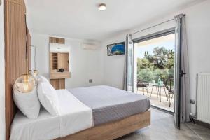 a bedroom with a bed and a balcony at Villa Elegio in Kavos +24 photos