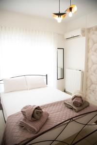 a bedroom with a bed with towels on it at Iasonas Apartment 2 in Nafplio