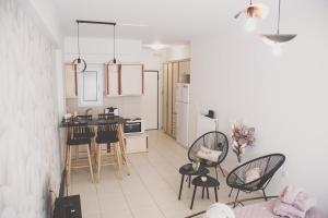 a kitchen with a table and chairs in a room at Iasonas Apartment 2 in Nafplio +24 photos