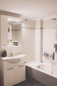 a white bathroom with a sink and a tub at Iasonas Apartment 2 in Nafplio