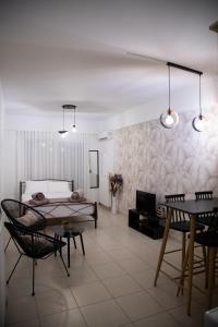 a bedroom with a bed and a table and chairs at Iasonas Apartment 2 in Nafplio