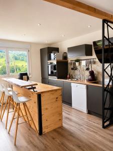 a kitchen with a large wooden table and chairs at Appart Vosges in Fresse-sur-Moselle