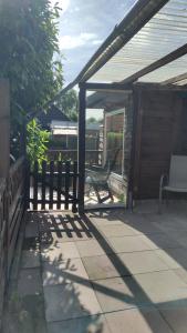 a patio with a wooden fence and a bench at Auf dem Land in Wittbek