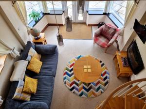 a living room with a couch and a table at Tramways Holiday Cottage in Carnbrea