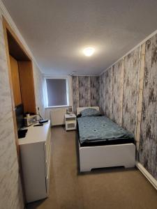 a small room with a bed and a desk at Worker's Home by Nina in Herzberg am Harz