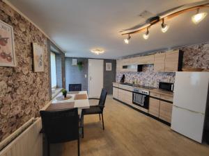 a kitchen with a table and a white refrigerator at Worker's Home by Nina in Herzberg am Harz