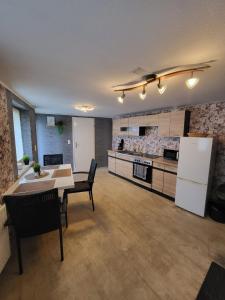 a large kitchen with a table and chairs and a refrigerator at Worker's Home by Nina in Herzberg am Harz