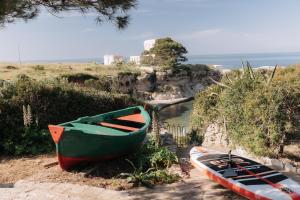 two boats sitting on the side of a river at Villa Incina - Sea House in Polignano a Mare +44 photos