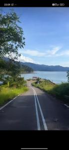 an empty road next to a body of water at The Kobe House 2 in Kuala Berang