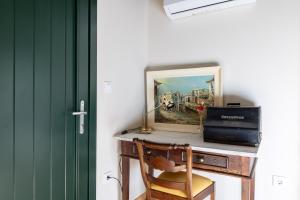 a desk with a chair and a picture on it at Casa do Capitan cdc in Leiro