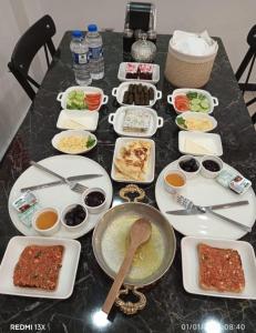 a table topped with plates and bowls of food at Çelik Crown Hotel in Trabzon +17 photos