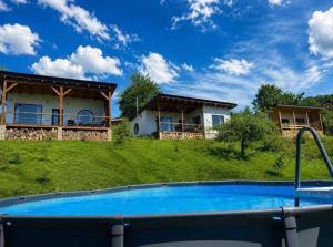 a swimming pool in front of a house at Secret place in Svalyava