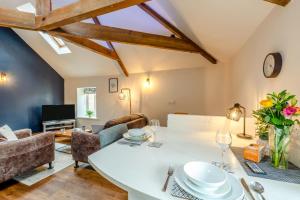 a kitchen and living room with a table and chairs at 1 Bed in Crakehall oc-o30357 in Crakehall
