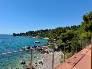 a view of the ocean from a boardwalk at Beachfront Luxury Villa - Bar in Bar