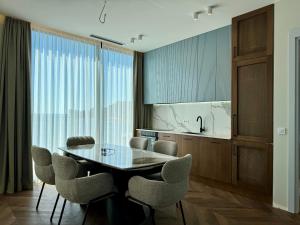a dining room with a table and chairs and a kitchen at Beachfront Luxury Villa - Bar in Bar +15 photos