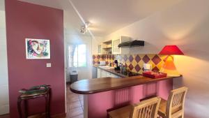 a kitchen with a wooden counter top in a room at Marisol les pieds dans l eau in Le Gosier