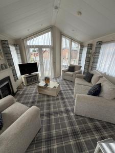 a large living room with couches and a tv at Sunnyside Lodge in Dunning Station
