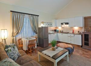 a kitchen and living room with a couch and a table at Great Dane at Brittlewood in Underberg