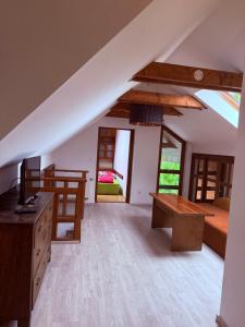 a attic room with a bed and a desk at Rodinný Penzion U Nouzů in Staré Hradiště