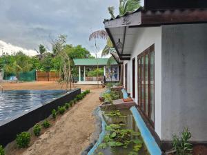 a building with plants on the side of it at Beach 365 in Nilaveli