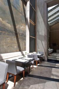 a dining room with tables and chairs and a mural at NH Córdoba Urbano in Córdoba +15 photos