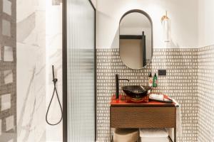 a bathroom with a sink and a mirror at Palazzo Rota Luxury Apartments in Venice +20 photos