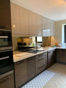 a kitchen with wooden cabinets and a stove top oven at River View Cottage in Newton Stewart