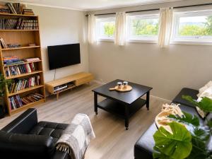 a living room with a couch and a coffee table at Jåsund SunView in Lyngdal
