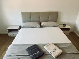 a large bed with two pillows on it in a room at SunnyOasis in Mostar