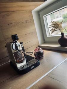 a coffee maker sitting on a floor next to a window at SunnyOasis in Mostar