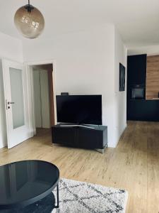a living room with a tv and a coffee table at SunnyOasis in Mostar