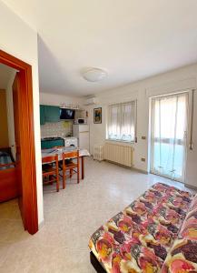 a living room with a bed and a dining room at VILLA ROSSINI in Valledoria