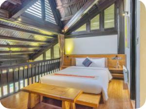 a bedroom with a white bed and a wooden table at Joy Villa Sapa in Sapa