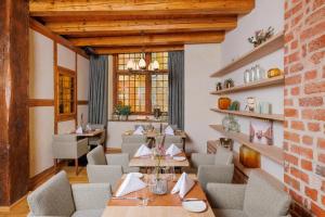 a dining room with tables and chairs and a brick wall at Scheelehof - Ein Lieblingsplatz Hotel in Stralsund