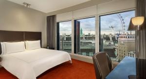 a hotel room with a bed and a large window at Park Plaza London Westminster Bridge in London