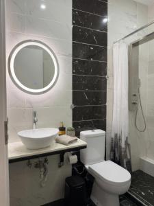 a bathroom with a sink and a toilet and a mirror at ILoveHome Mini in Kalamata