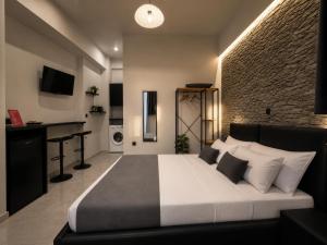 a bedroom with a large bed and a desk in it at ILoveHome Mini in Kalamata