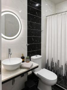 a bathroom with a sink and a toilet and a mirror at ILoveHome Mini in Kalamata +4 photos