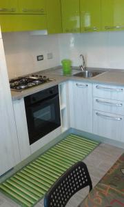 a kitchen with a stove and a sink at Appartamento Oro in Arma di Taggia