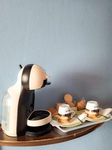 a coffee maker sitting on top of a shelf with food at Hotel Imperial in Tazones