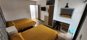 a small room with two beds and a fireplace at Hotel Angeles in Ciudad Serdán