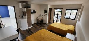 a room with two beds and a sink in it at Hotel Angeles in Ciudad Serdán